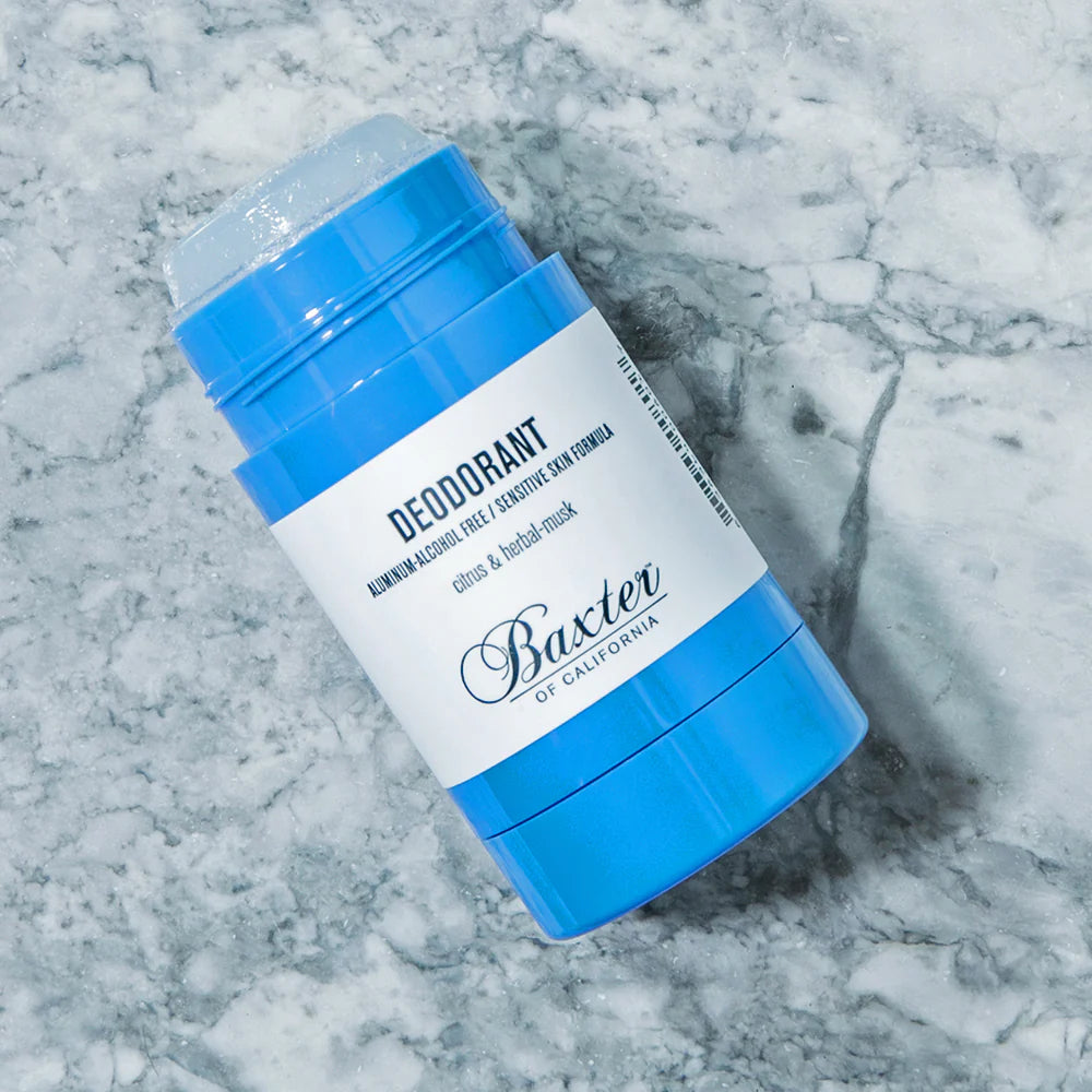 Blue and white deodorant stick on a marble surface