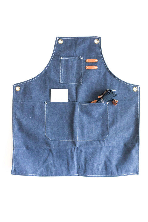 Blue apron with tool pockets on a white background